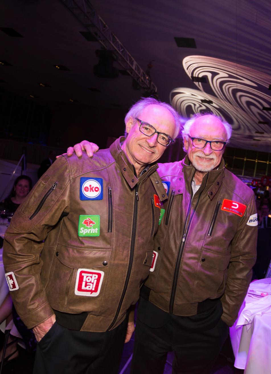 Two men in matching vintage leather jackets.
