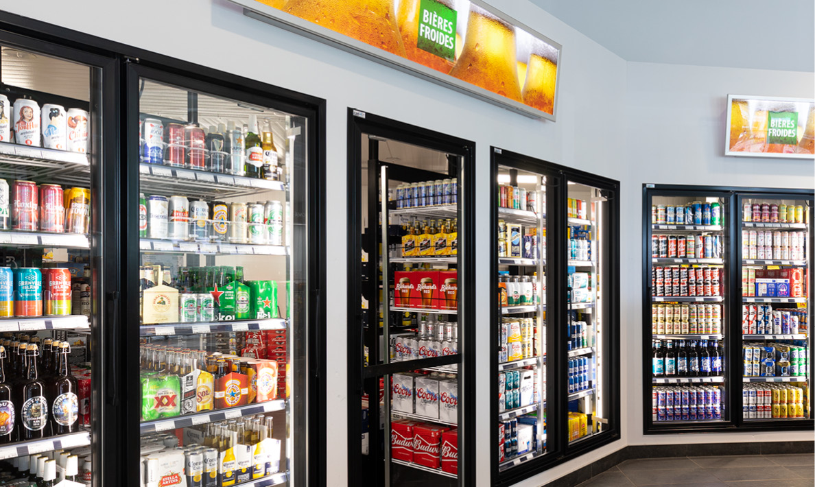 Refrigerated beverage section with various drinks displayed.