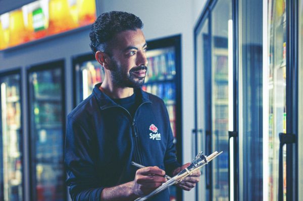 Store worker checking inventory with clipboard