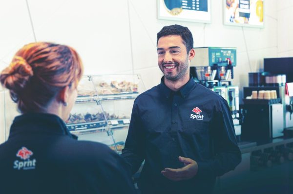 Sprint employees talking at a coffee shop.